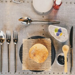 a table topped with a plate of food and silverware
