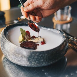 a person is spooning something into a plate